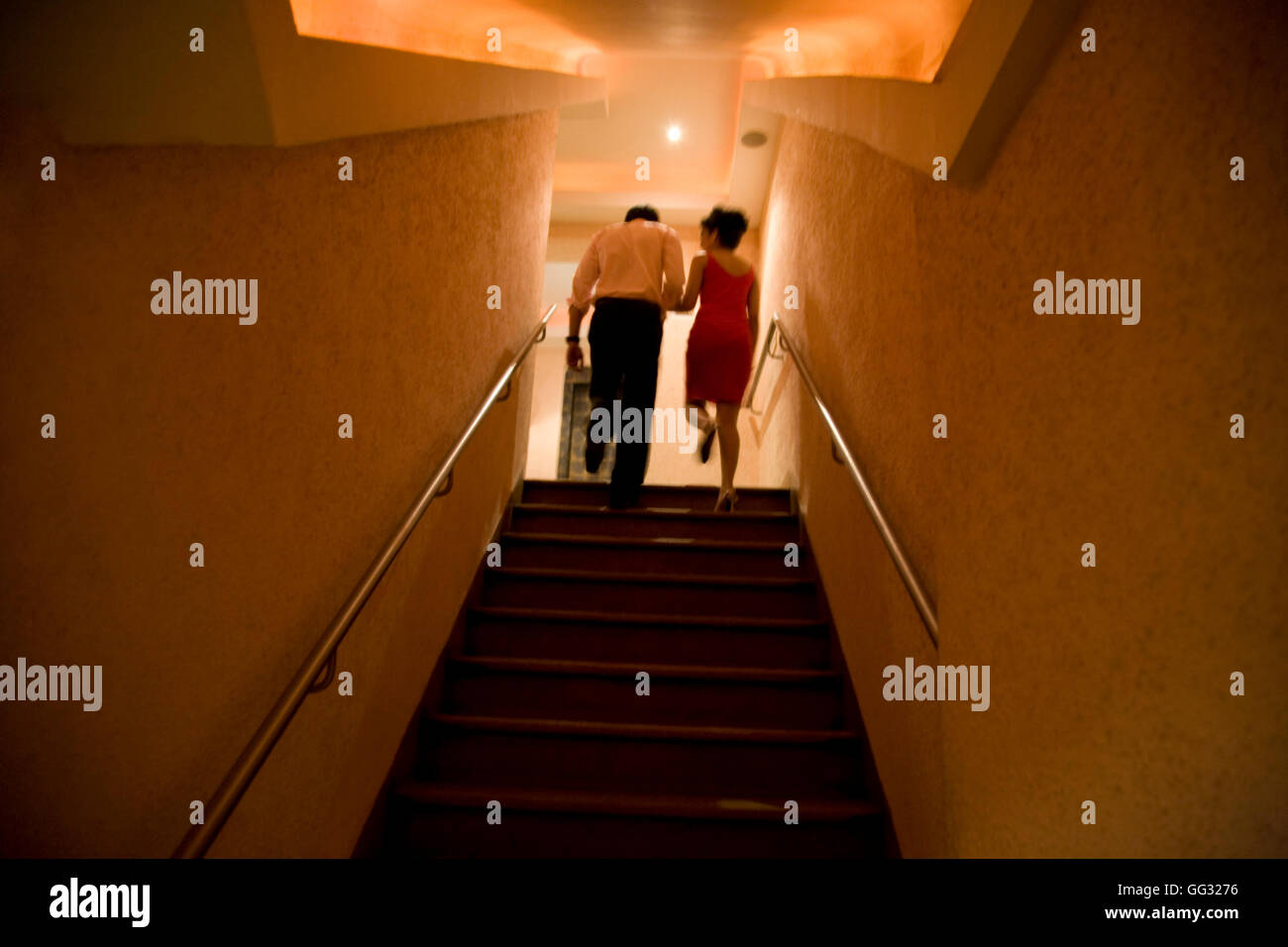 Woman Climbing Stairs Indoors Stock Photos & Woman Climbing Stairs