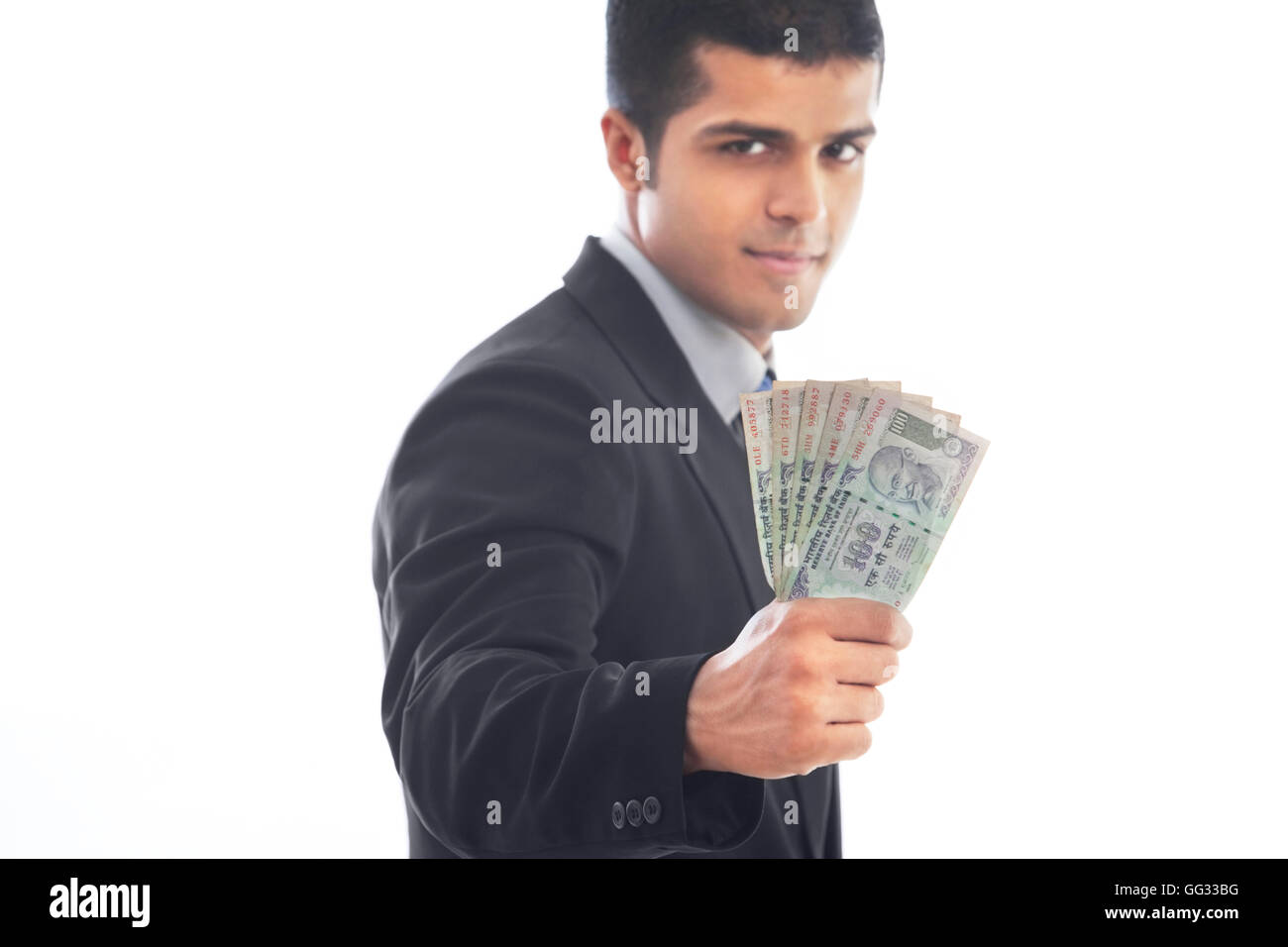 Handsome business man holding Indian currency over white background ...