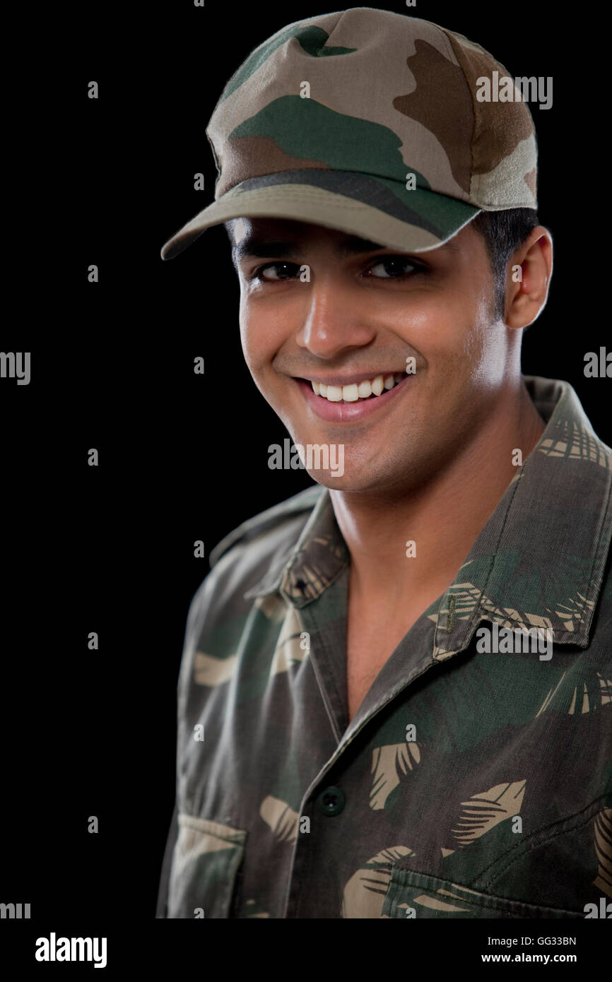 Portrait of smiling male soldier over black background Stock Photo - Alamy