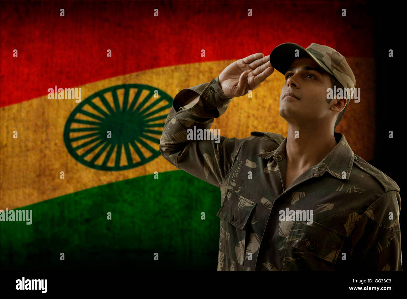 Soldier saluting with Indian flag in background Stock Photo