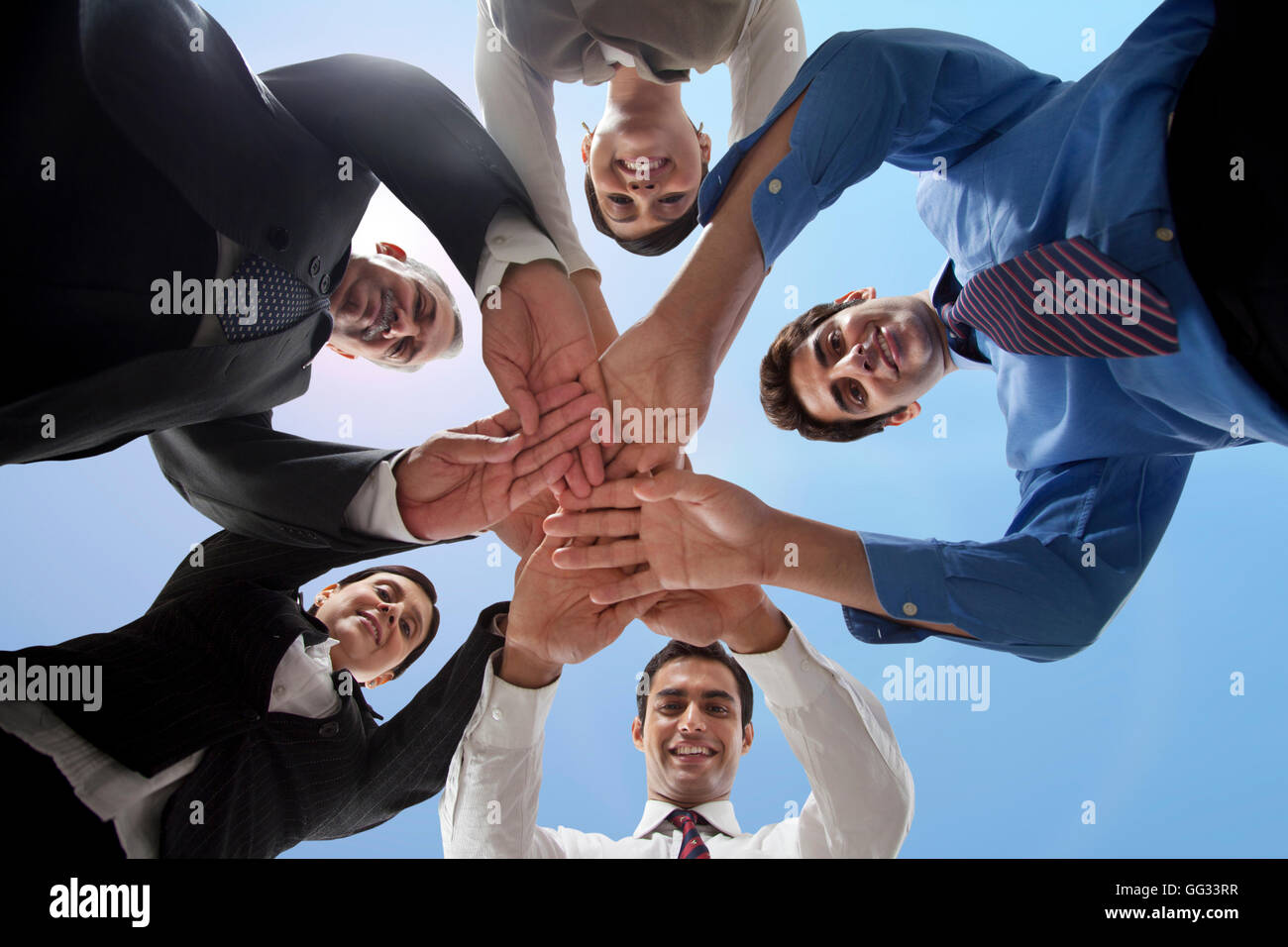 Low angle view of business people stacking hands Stock Photo - Alamy