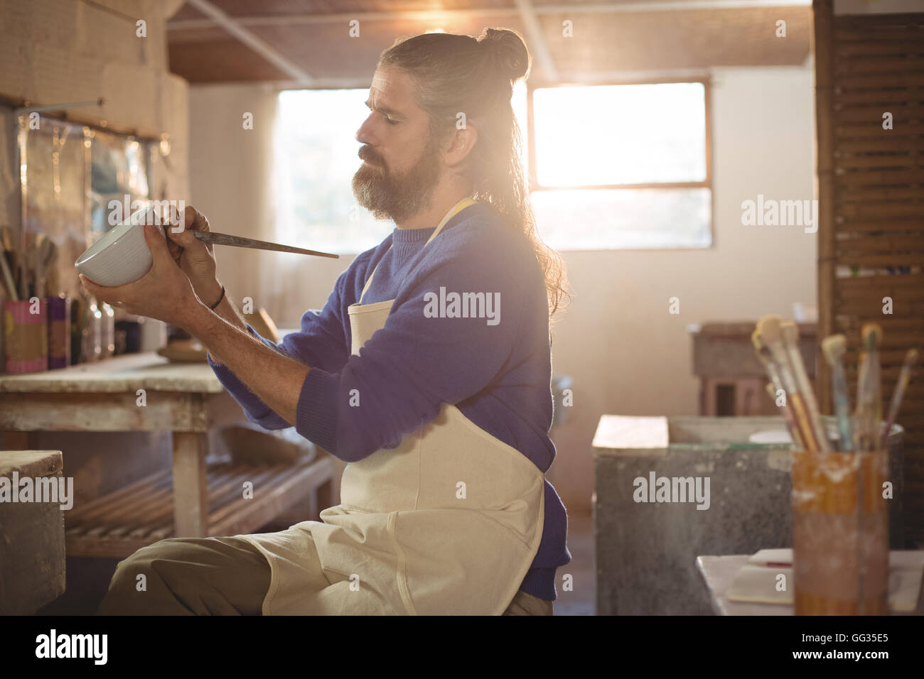 Male potter carving on pot Stock Photo - Alamy