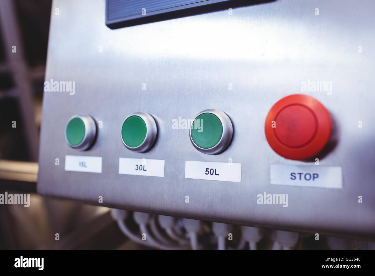 Stop button on machinery at brewery Stock Photo
