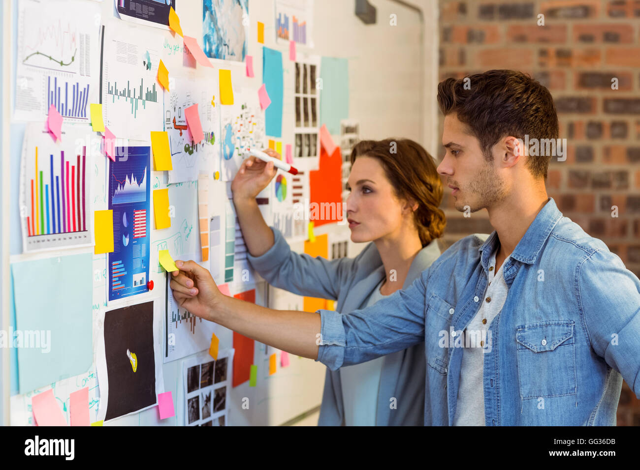 Business executives putting sticky notes on whiteboard Stock Photo - Alamy