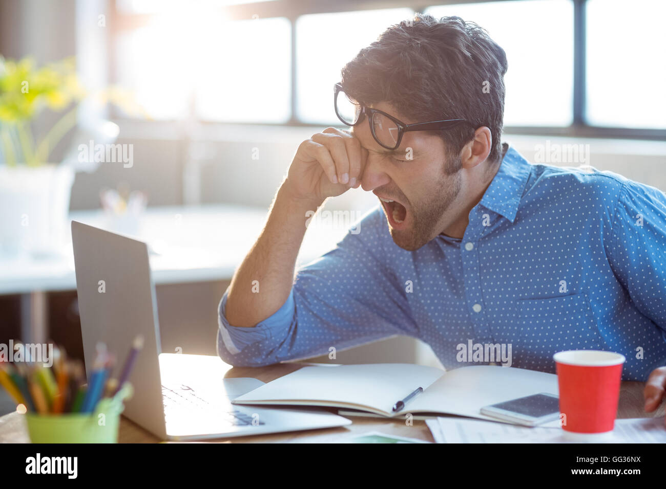 Male business executive yawning Stock Photo - Alamy