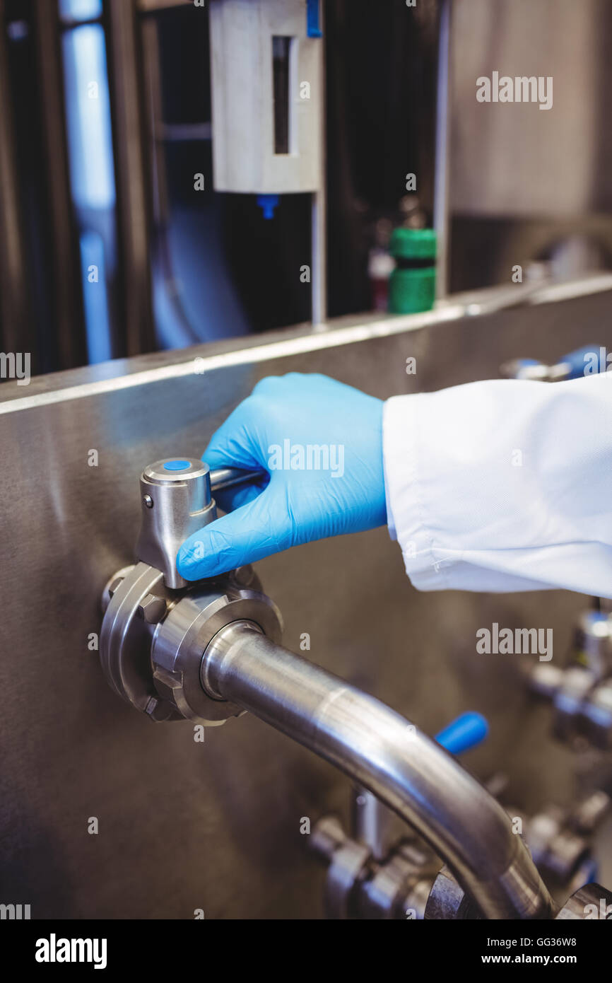 Manufacturer holding pipe at distillery Stock Photo