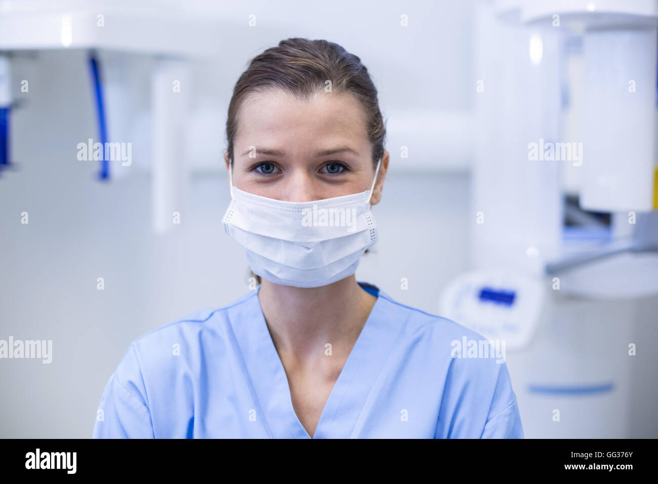 Dental assistant wearing surgical mask in dental clinic Stock Photo Alamy
