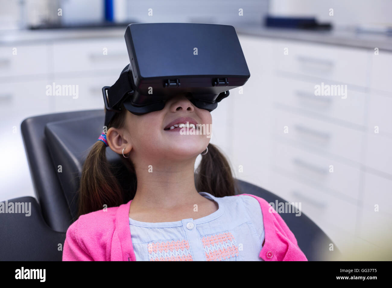 Girl using virtual reality headset during a dental visit Stock Photo