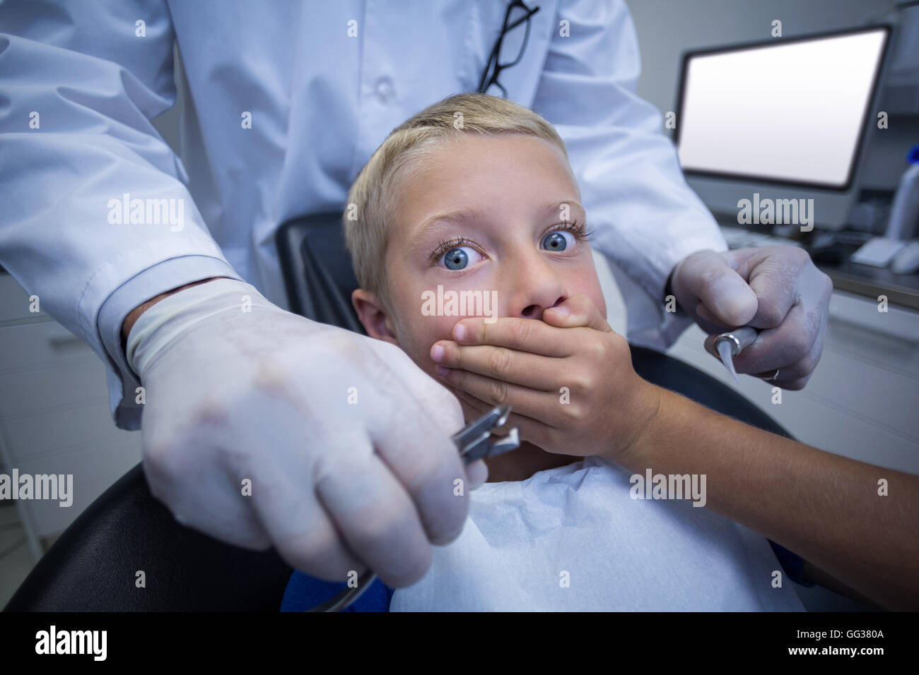 Young patient scared during a dental check-up Stock Photo