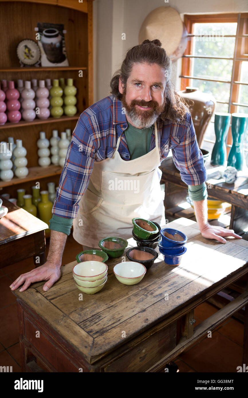 Portrait of male potter standing at table Stock Photo