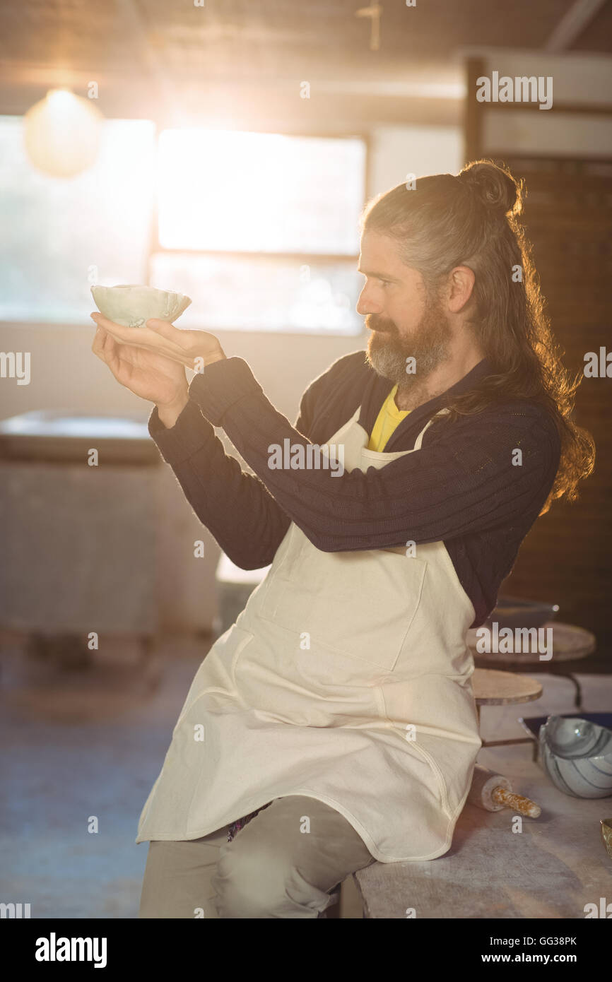 Male potter checking bowl Stock Photo - Alamy