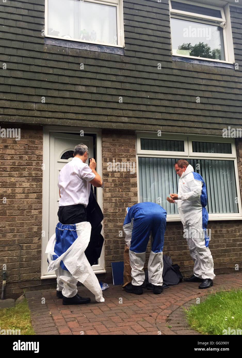 Forensic officers prepare to enter a property in Velville Court, Newcastle upon Tyne, after a man and woman were arrested on suspicion of the murder of a 13-week-old baby boy. Stock Photo