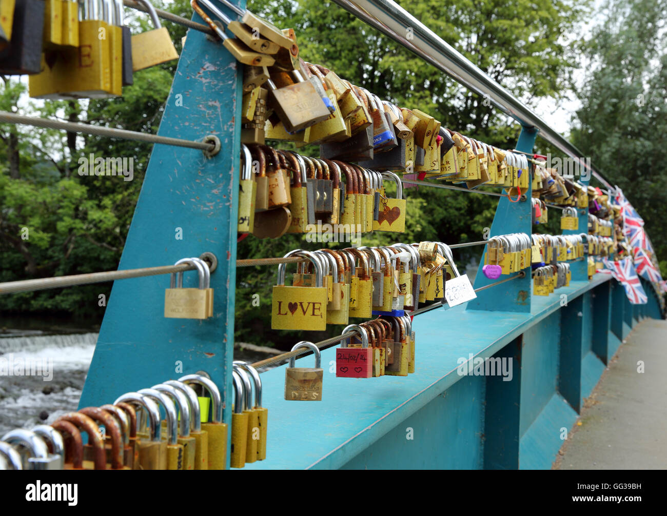 Padlocks depicting a loving relationship, fastened round cables supporting a bridge over the