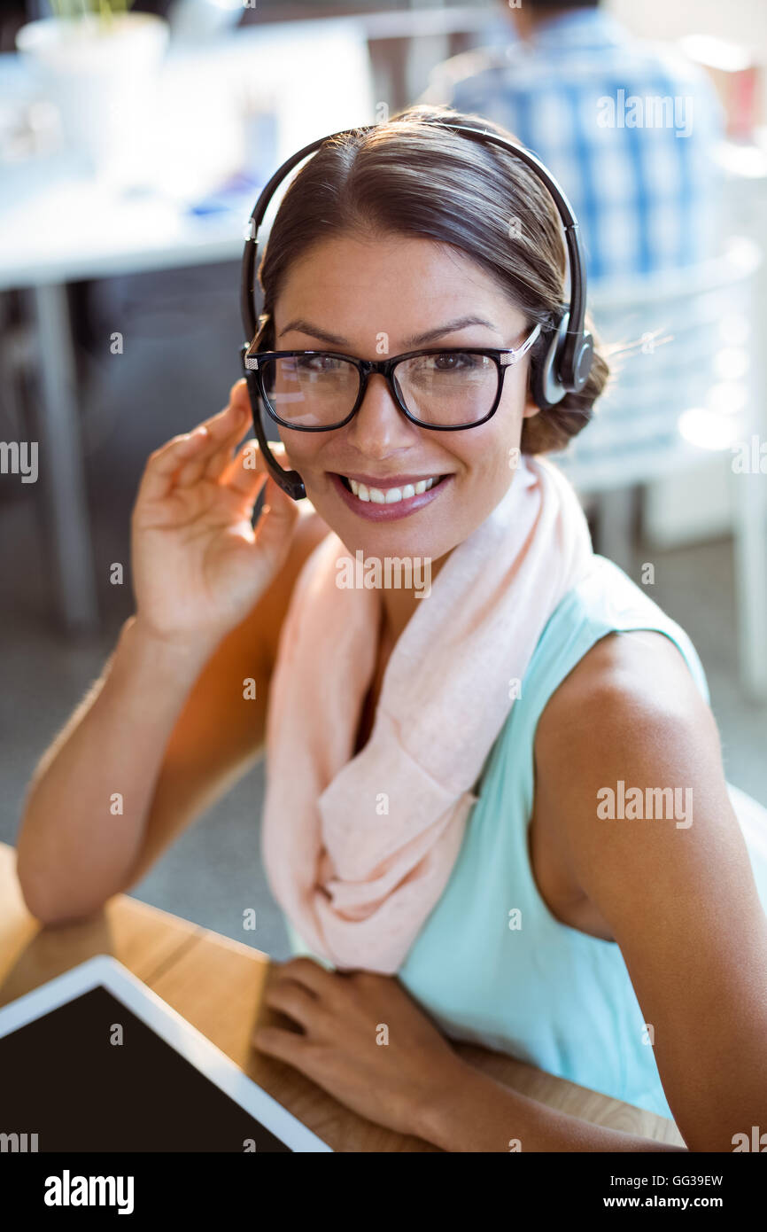 Business executive wearing headphones in office Stock Photo Alamy