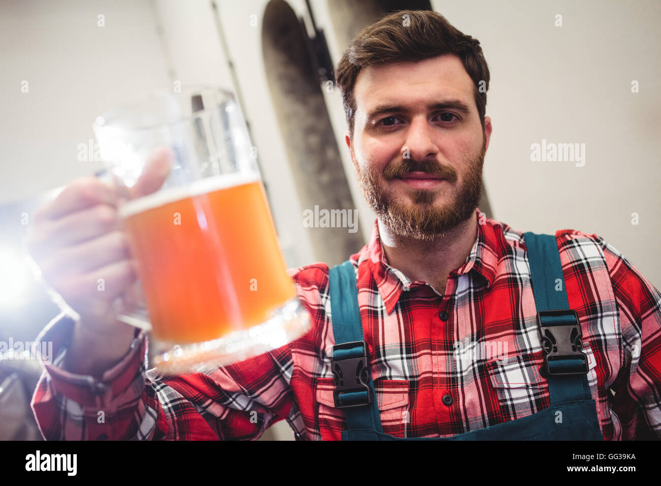 Portrait of manufacturer holding beer jug Stock Photo