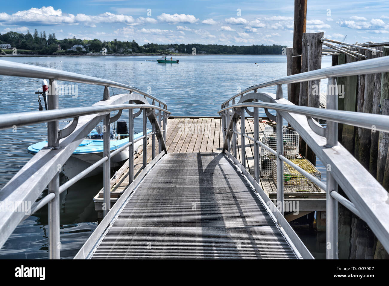 A floating dock with a lobster boat in the distance at Searsport, Maine
