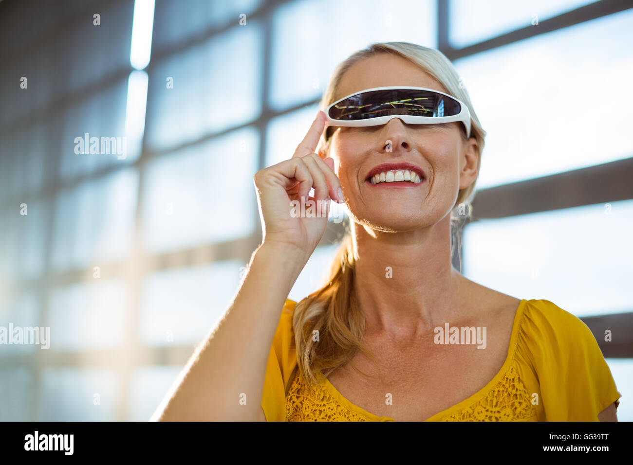 Female business executive using virtual reality video glasses Stock