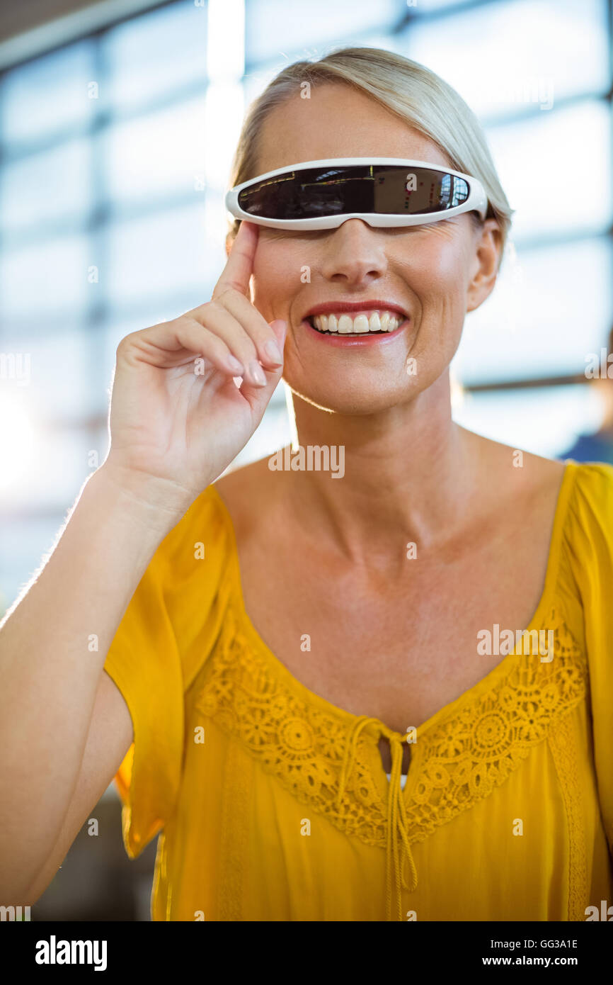 Female business executive using virtual reality video glasses Stock