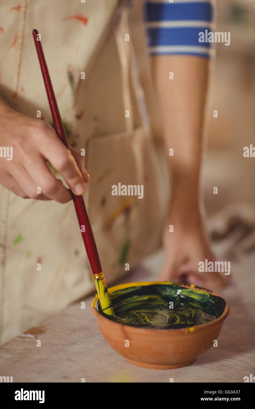 Mid section of potter mixing watercolor in bowl Stock Photo - Alamy