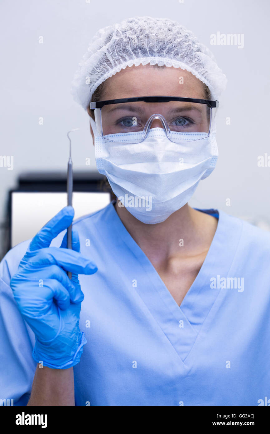 Dental assistant holding dental tool Stock Photo Alamy