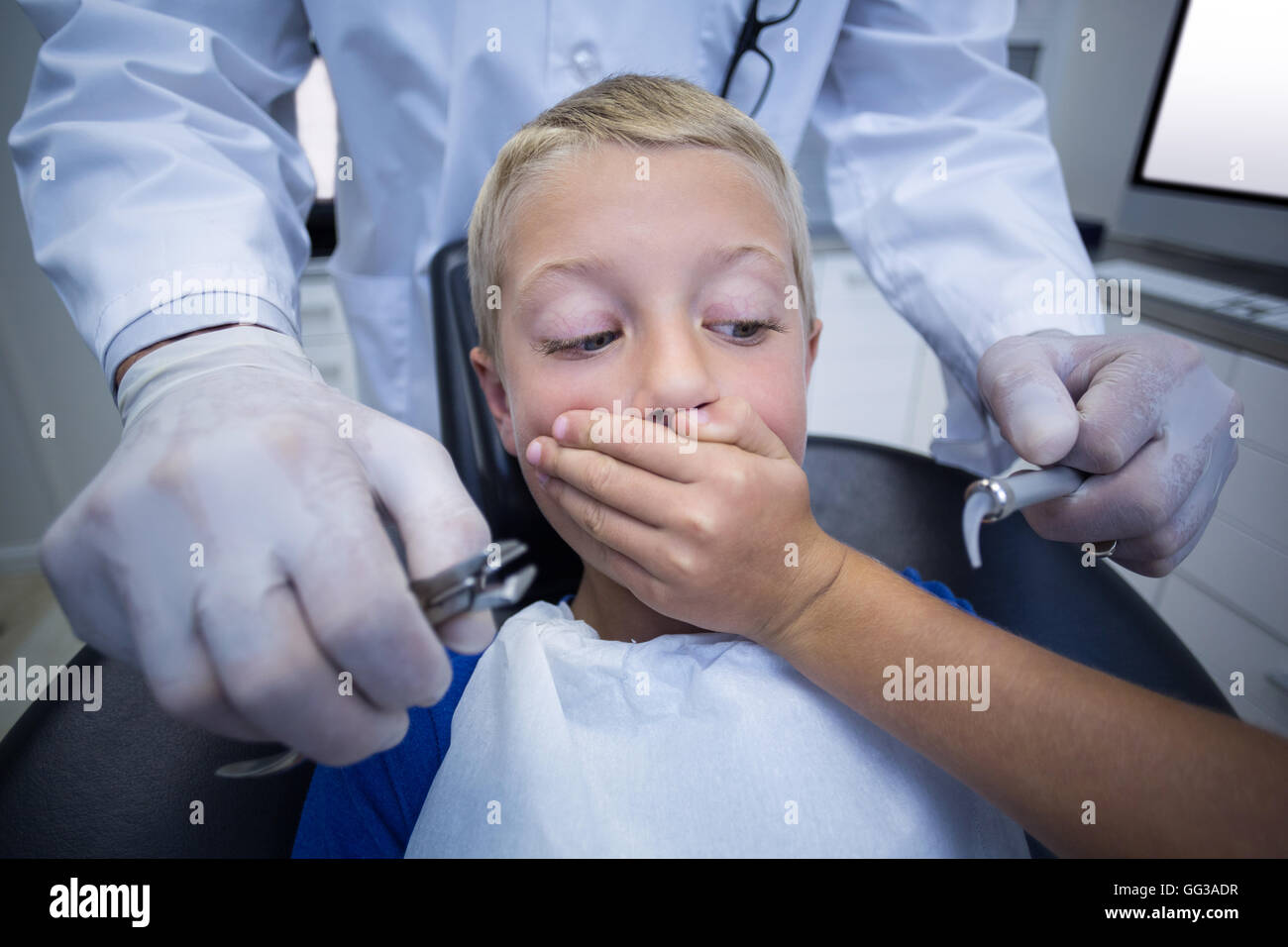 Young patient scared during a dental check-up Stock Photo