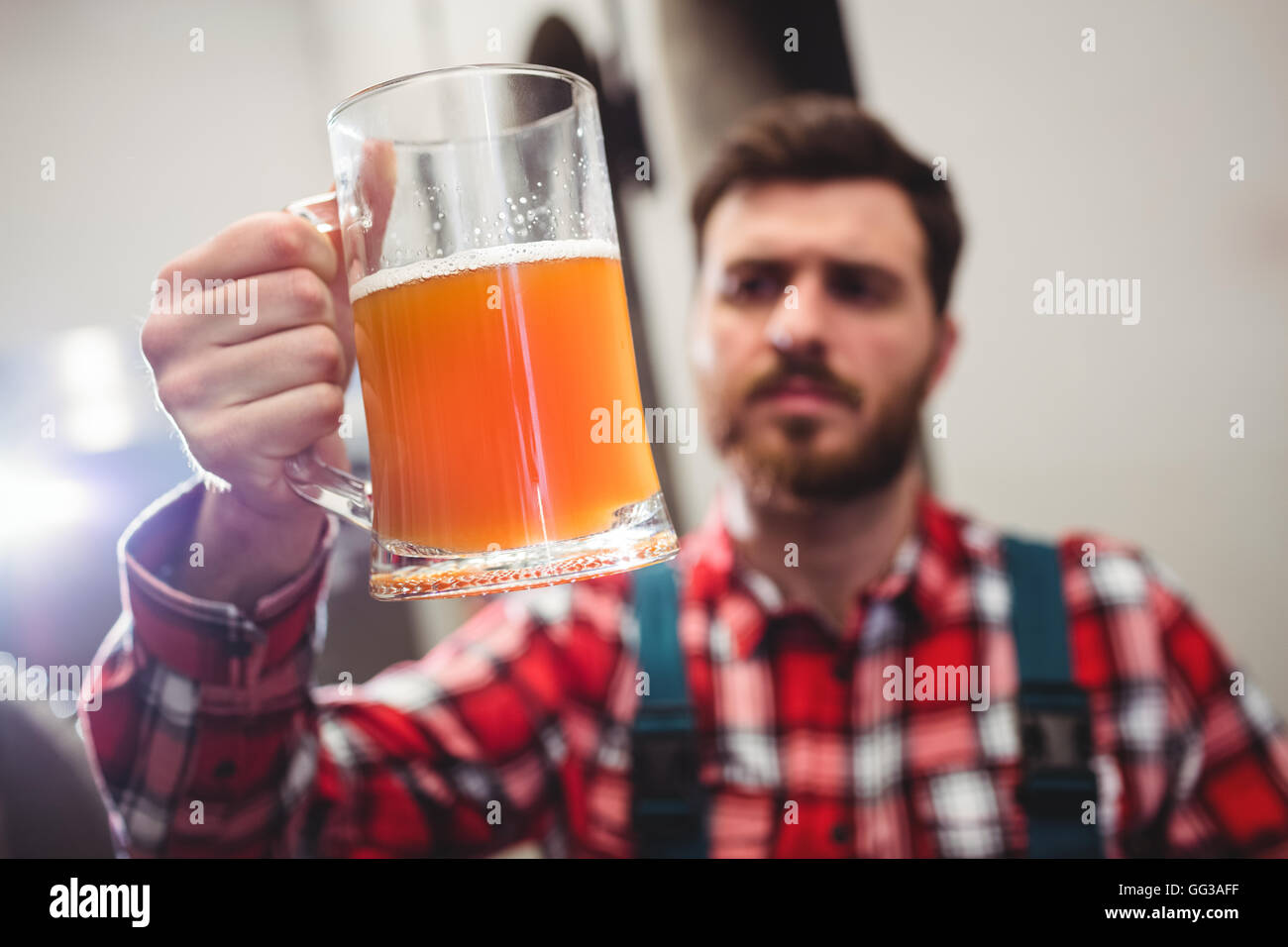 Manufacturer holding beer in jug Stock Photo