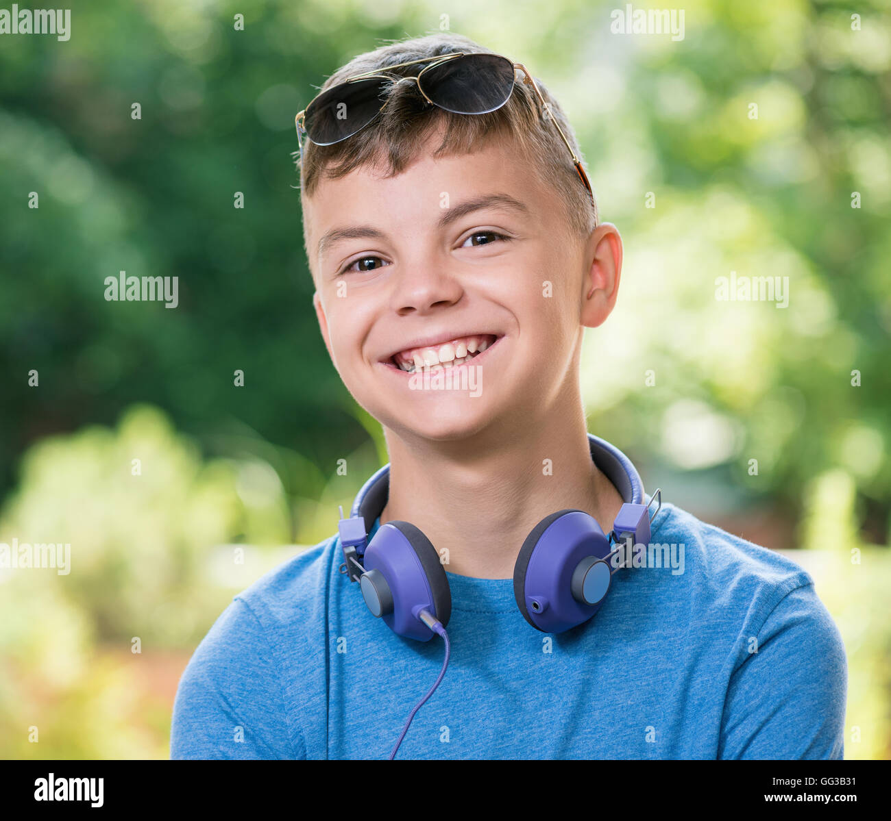 Teen Boy 12-14 Year Old Drinking Fresh Water From A Bottle. Student Teenager  With Headphones And Sunglasses Posing Outdoors. Stock Photo, Picture and  Royalty Free Image. Image 60008603.