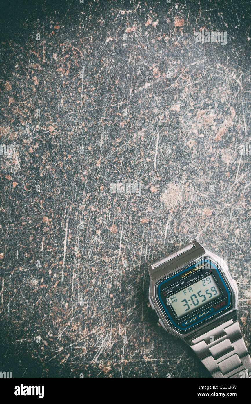 Digital watch on crackle background. Vintage filter. Stock Photo