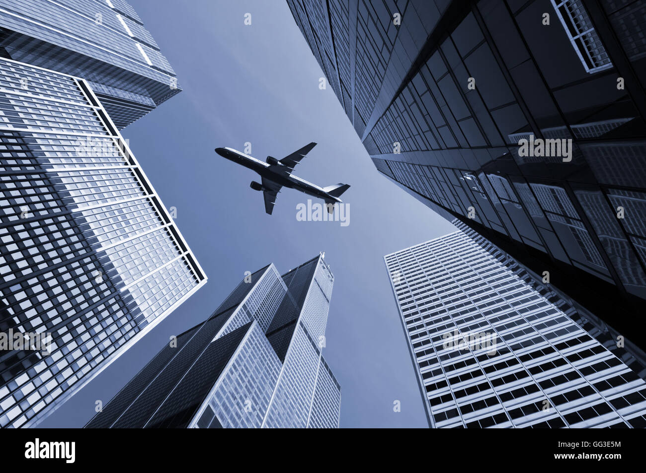 Airplane above city of Chicago. Image of airplane flying above Chicago downtown district. Stock Photo