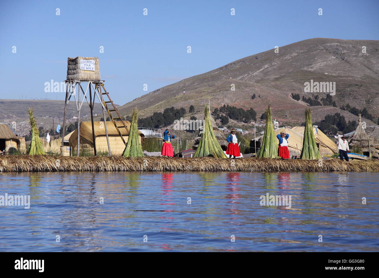 Floating reed village on Lake Titicaca, Peru, with Uros villagers Stock