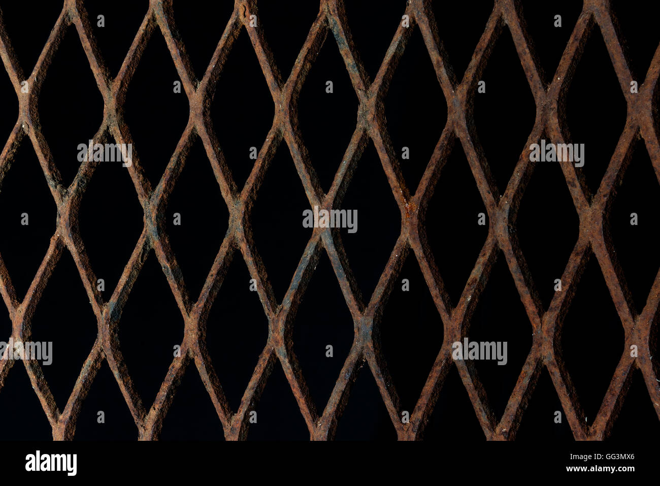 Texture or background of rusty expanded metal on black background Stock Photo