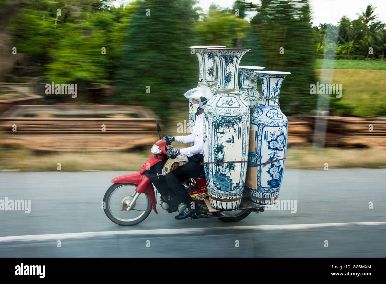 Motorbike carrying vases on the street of Vietnam, near Saigon, countryside Stock Photo