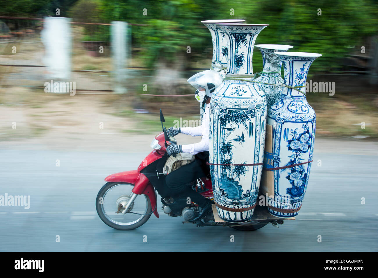 Motorbike carrying vases on the street of Vietnam, near Saigon, Stock Photo