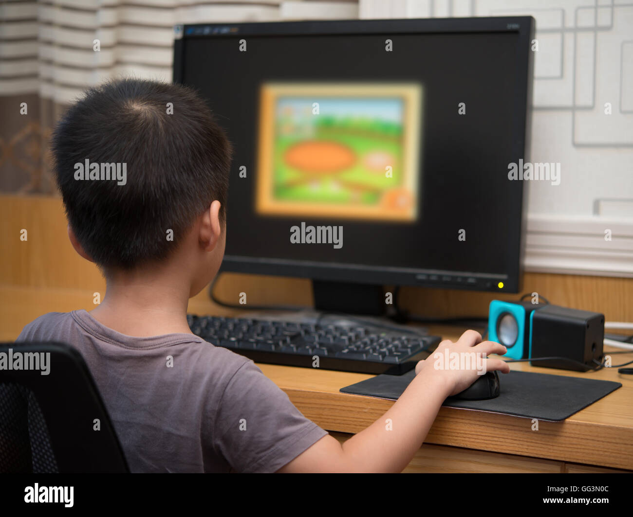 kid playing a computer game for children at home Stock Photo