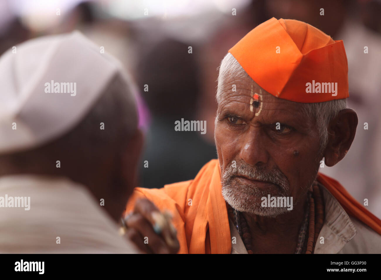 An old Indian hindu pilgrim wearing traditional hat in the hindu