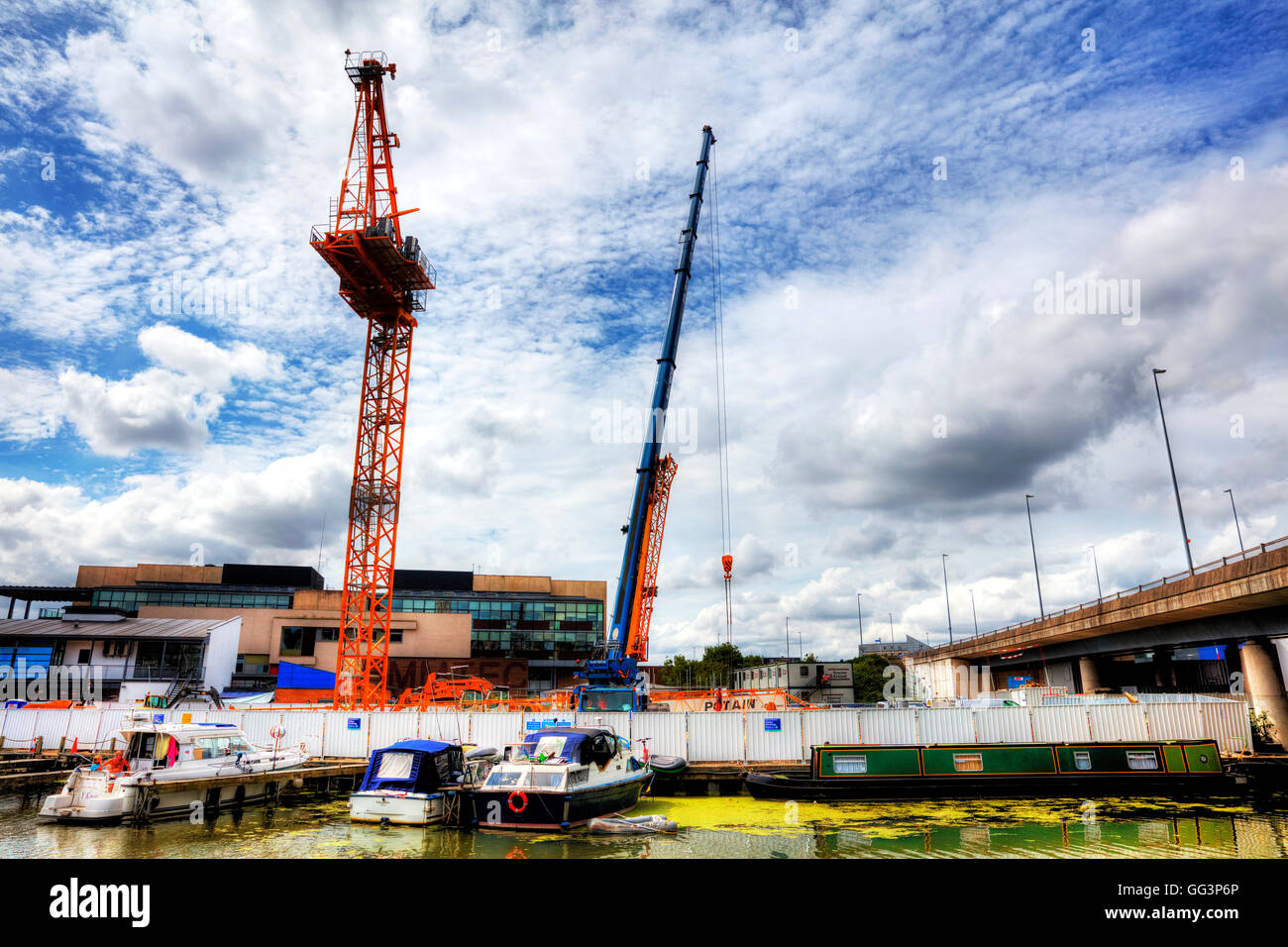 Construction crane constructing buildings building site by the river Witham Brayford pool Lincoln City Lincolnshire UK England Stock Photo