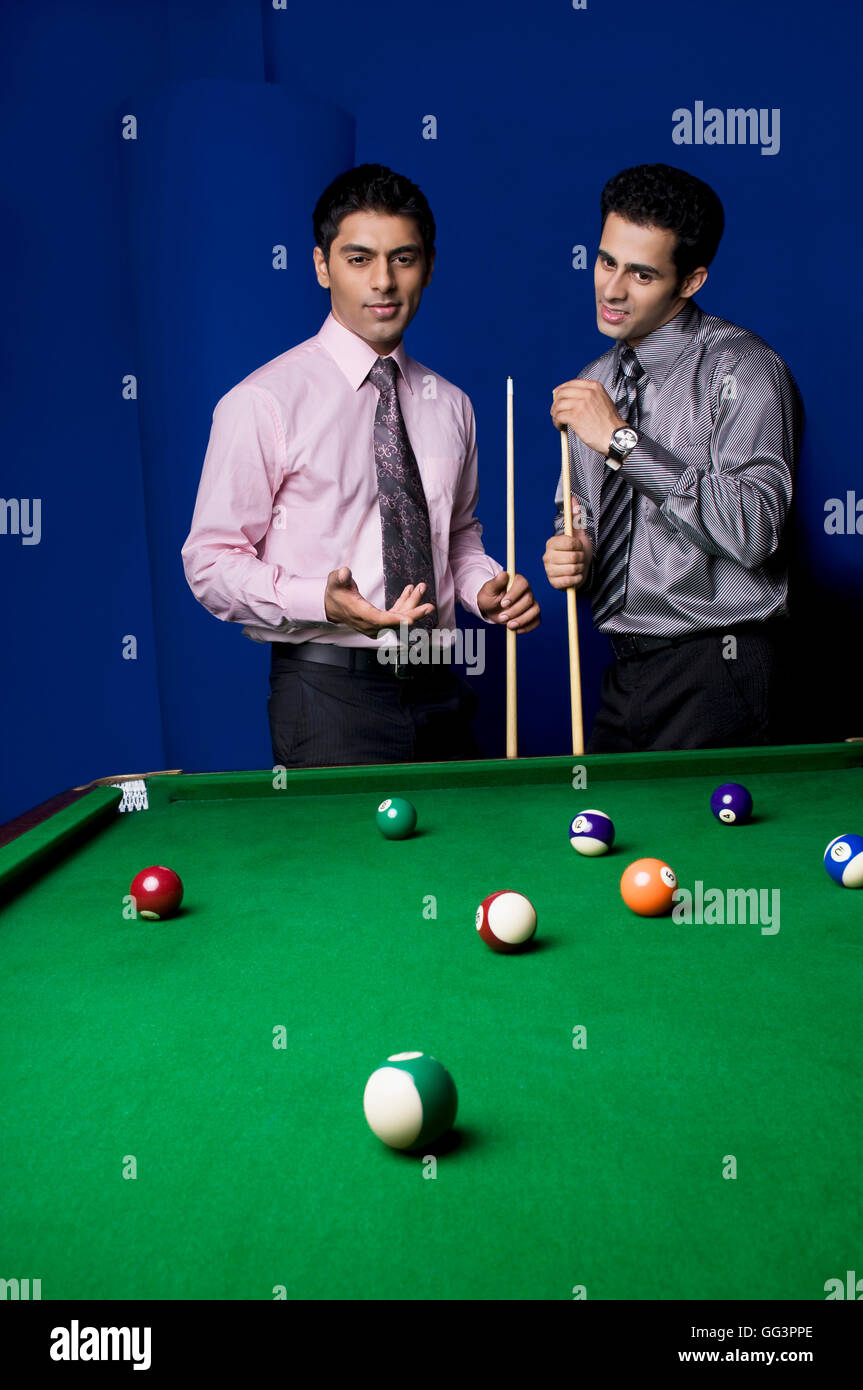 Colleagues playing pool Stock Photo - Alamy
