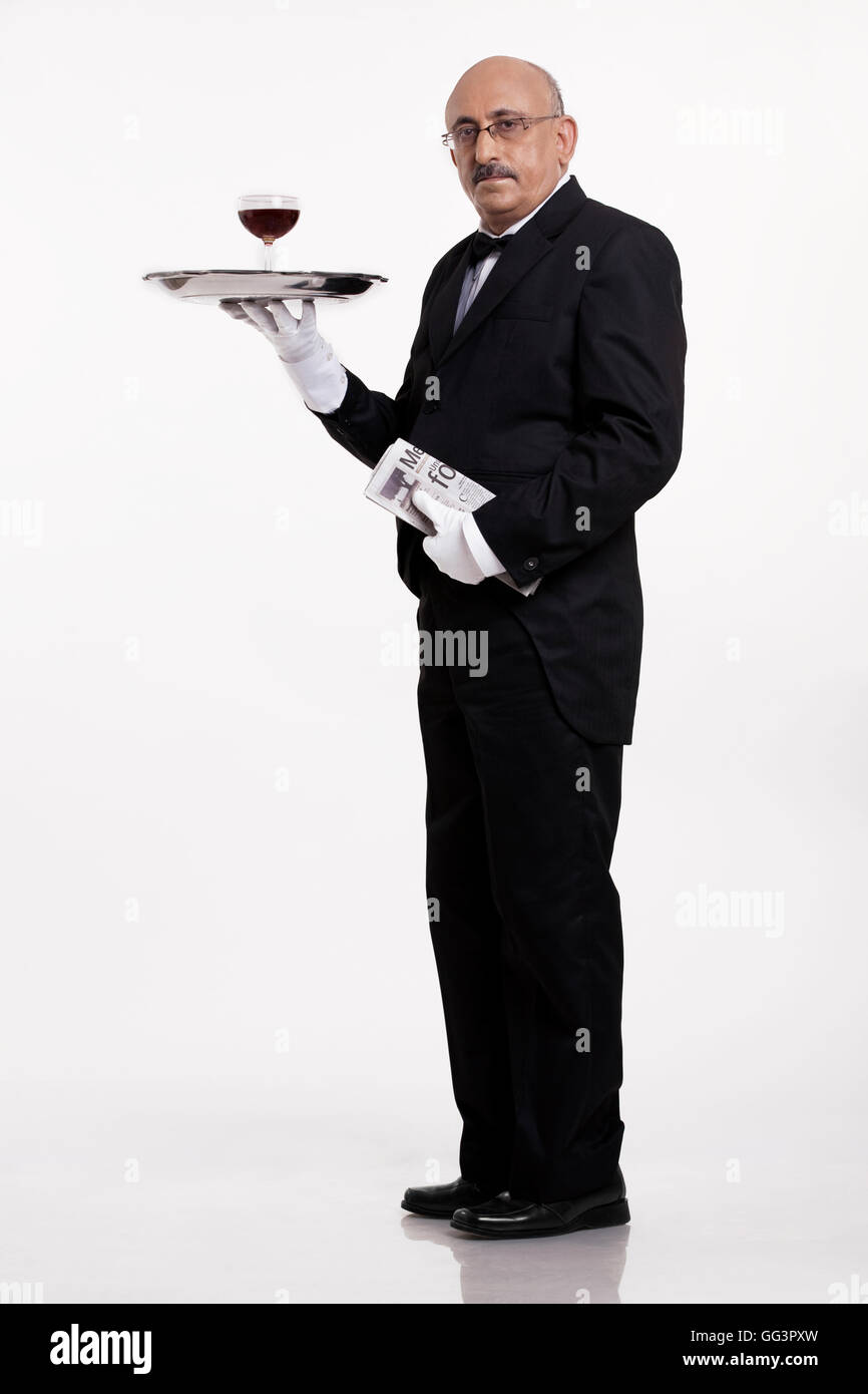 A butler serving a drink Stock Photo
