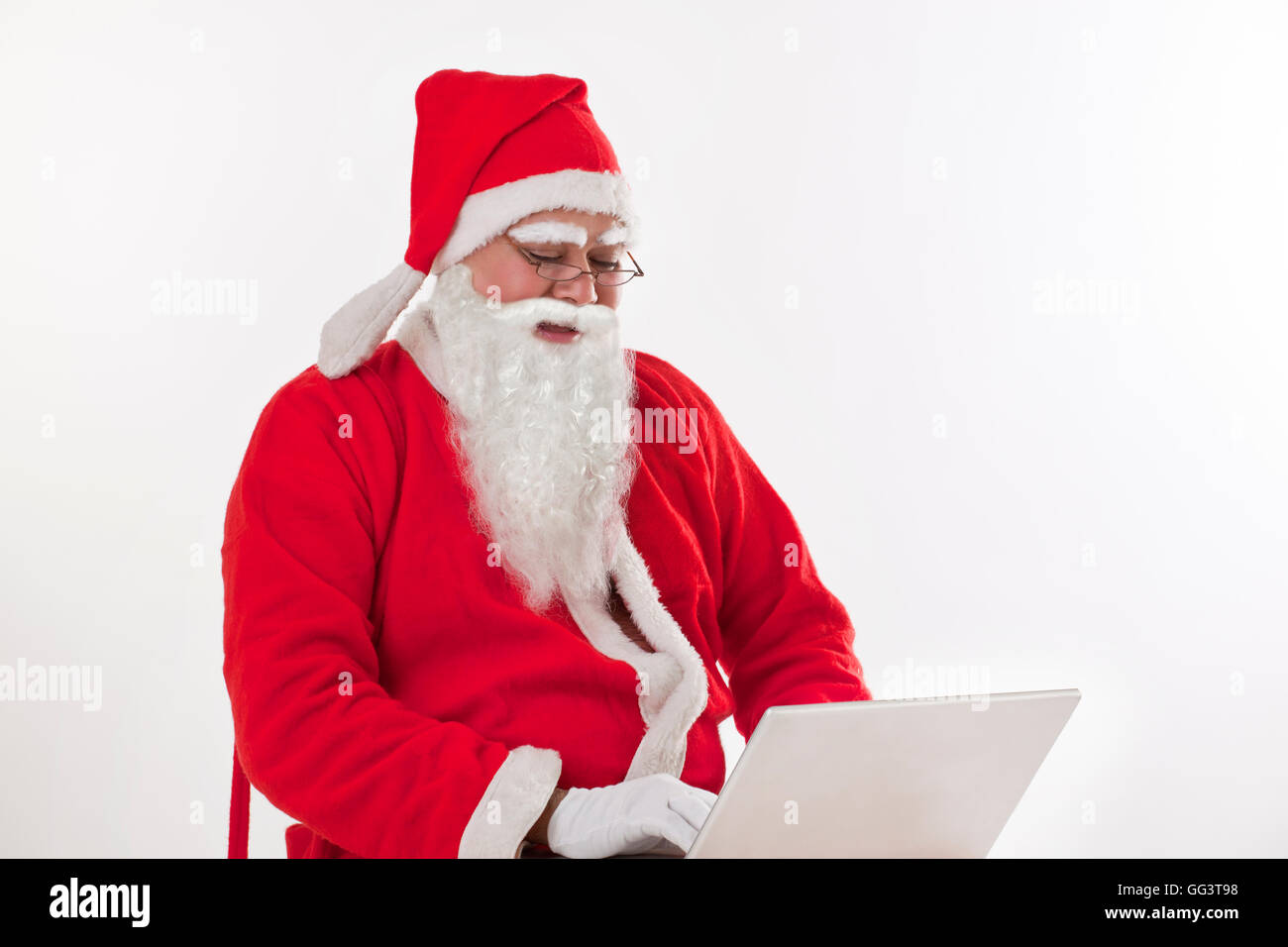 Santa Claus operating laptop over white background Stock Photo - Alamy
