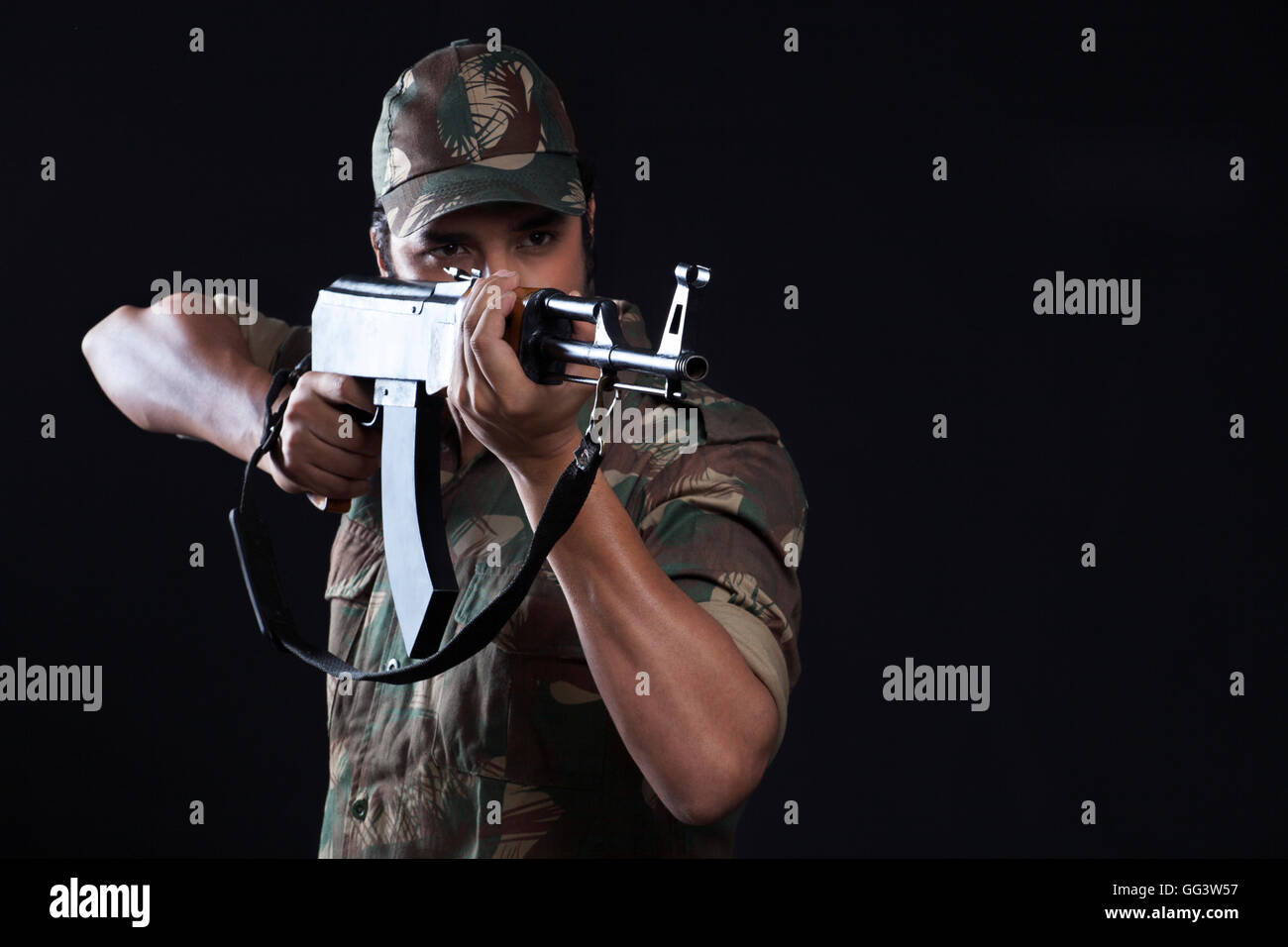 Young army man aiming with a rifle Stock Photo