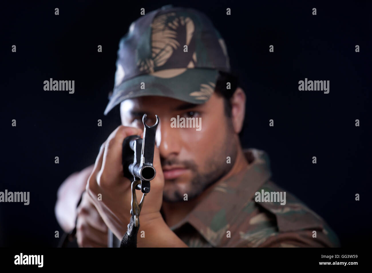 Portrait of army man aiming with a rifle Stock Photo
