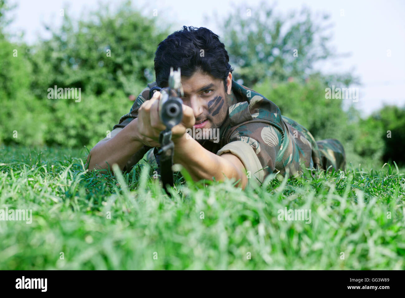 Young soldier aiming with rifle Stock Photo - Alamy