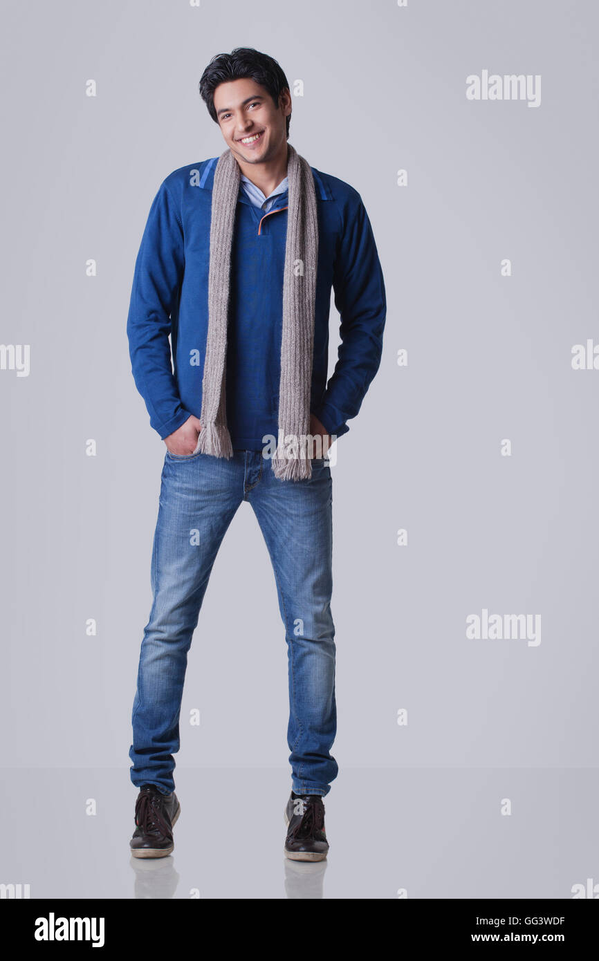 Portrait of smiling young man over grey background Stock Photo - Alamy