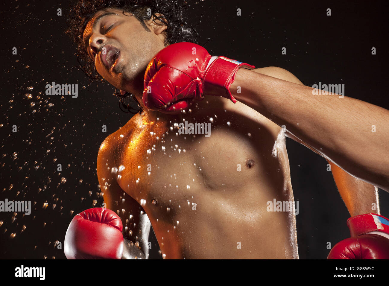 Boxer taking hit from opponent Stock Photo - Alamy