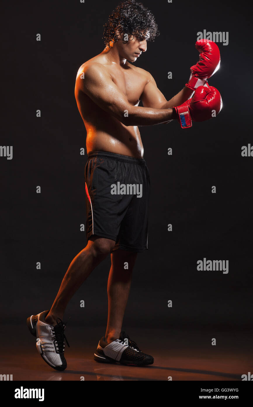 Full length of young boxer wearing gloves Stock Photo Alamy