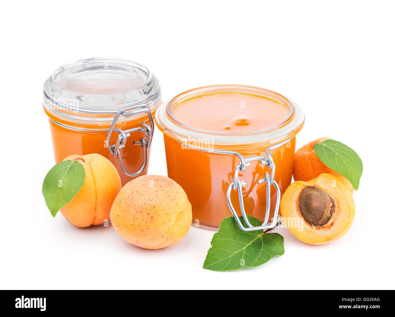 Two jars of apricot jam and fresh fruits isolated on white Stock Photo