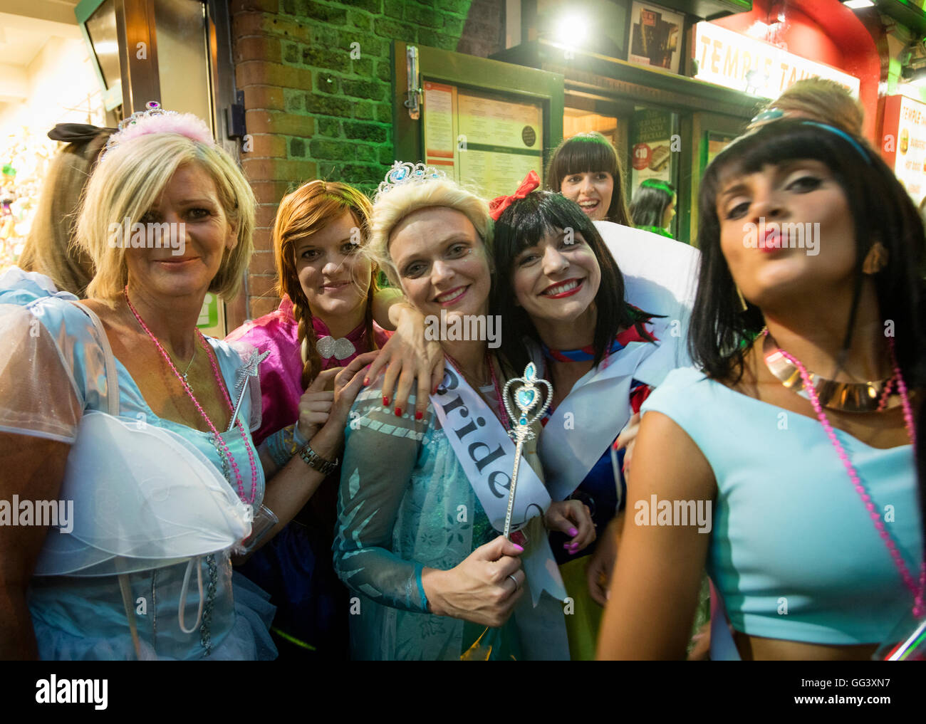 party of women in fancy dress celebrating in street at night in Temple Bar, Dublin, Ireland Stock Photo