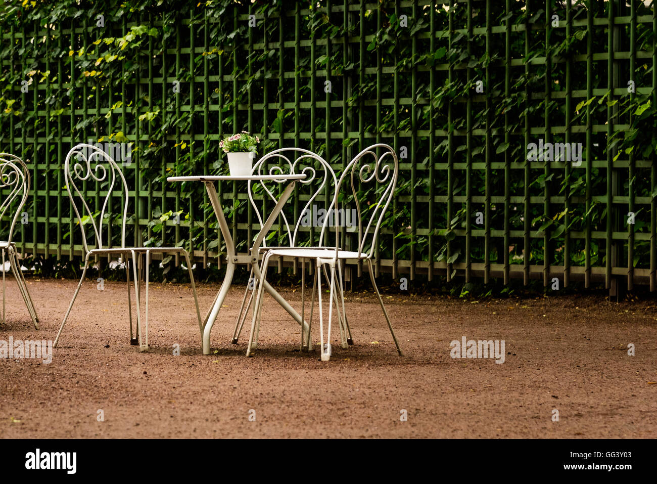 Modern set of white tables in the Park cafe in the rain Stock Photo