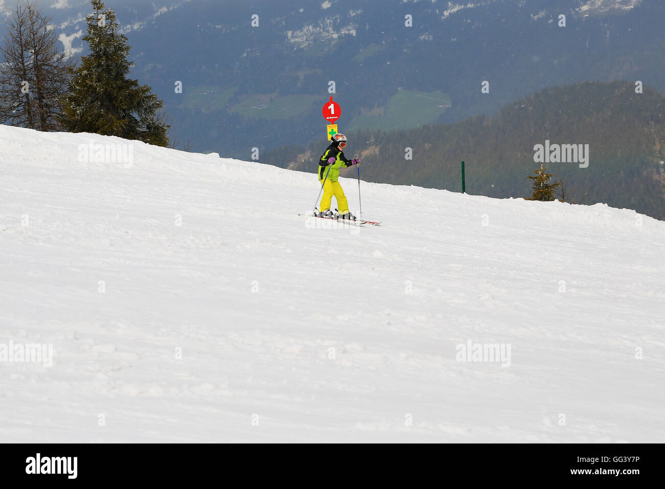 Skiing girl in ski mask and helmet on Dachstein resort in Austria Alps