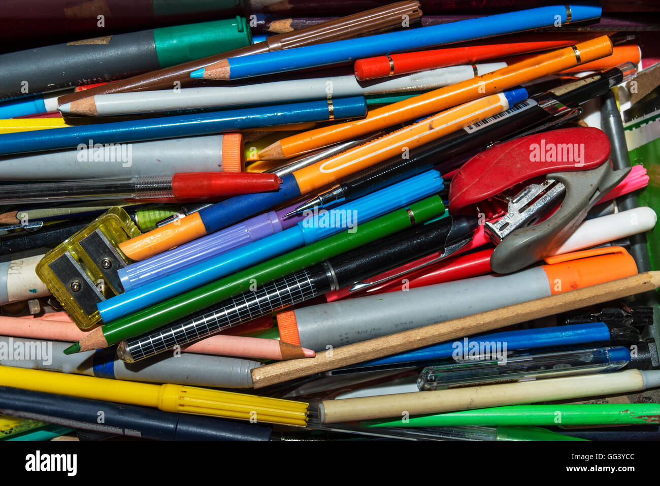 many school supplies, pencils, markers, pencil sharpeners and others placed as background Stock Photo
